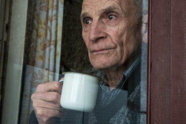 Elderly man at window