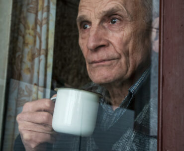 Elderly man at window