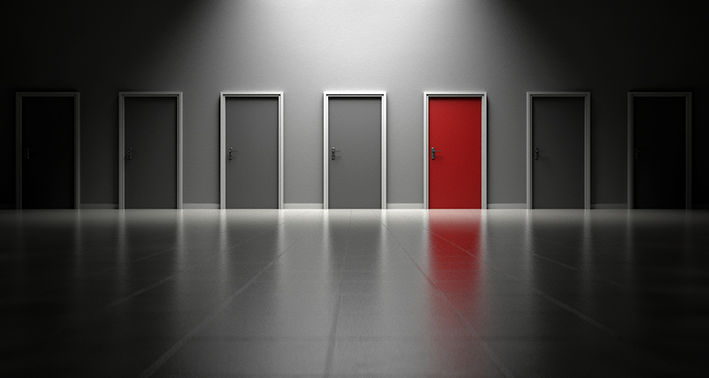 Grey hallway will selection of grey doors and one red door