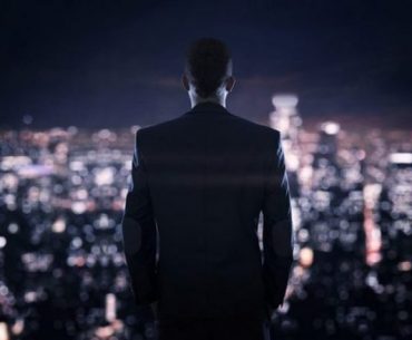 Businessman looking at the the city at night